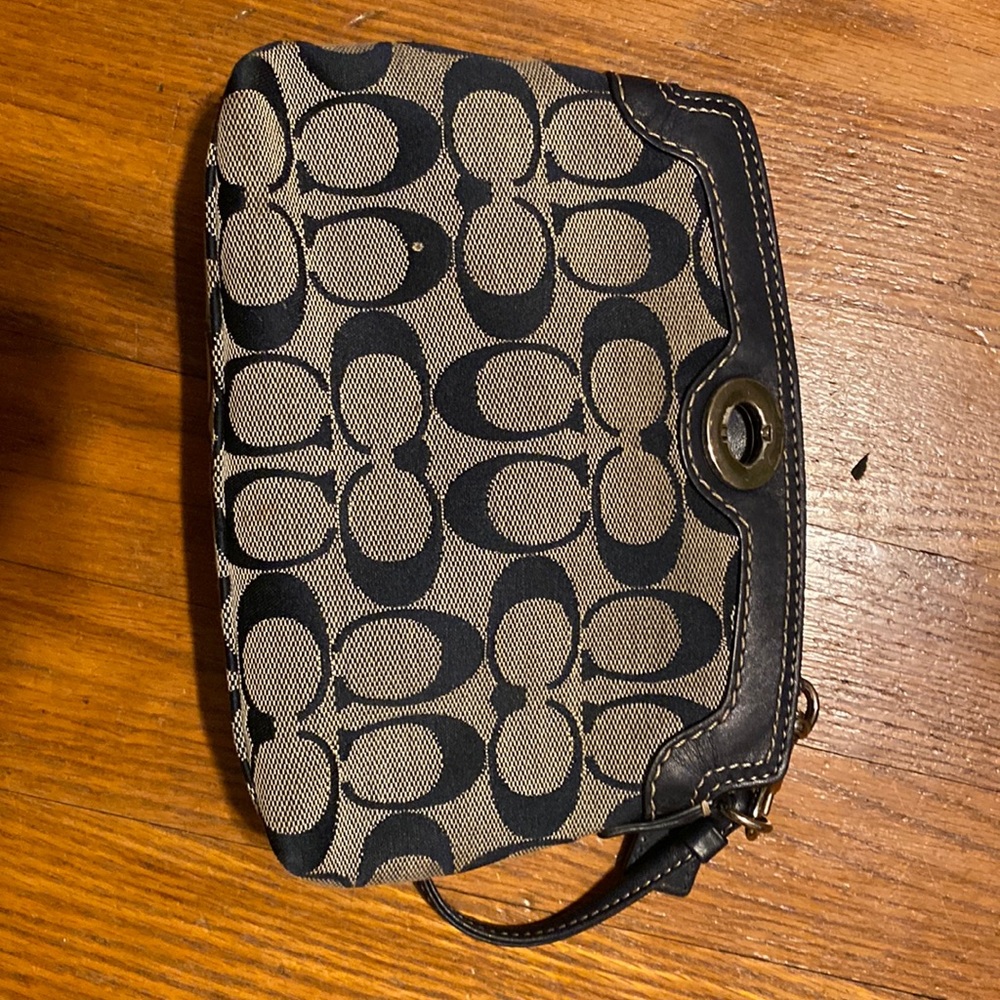 Coach navy blue wristlet. Slightly used.  Fits IPhone.